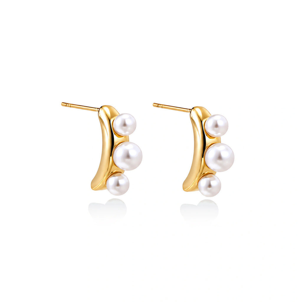 14K gold-plated curved stud earrings with three white freshwater pearls aligned vertically on cream background