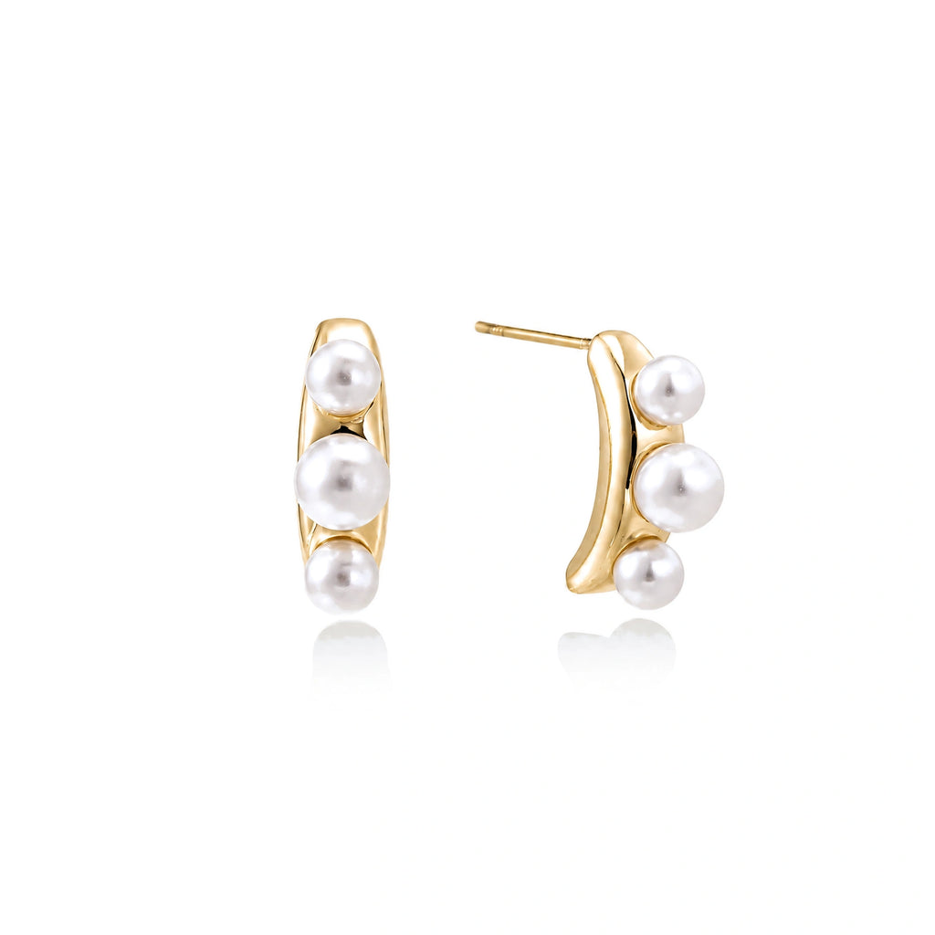 14K gold-plated curved stud earrings with three white freshwater pearls aligned vertically on cream background